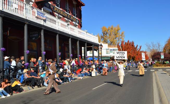 Members of the Nevada Women's History Project carry signs from the suffrage movement during the Nevada Day parade in Carson City on Oct. 26, 2013.